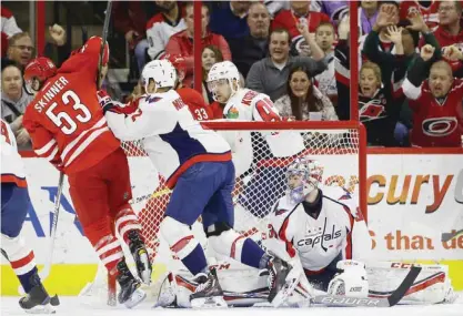  ?? — AP ?? RALEIGH: Carolina Hurricanes’ Jeff Skinner (53) scores against Washington Capitals goalie Philipp Grubauer, of Germany, as Capitals’ Matt Niskanen (2) defends during the first period of an NHL hockey game in Raleigh, N.C., Friday.