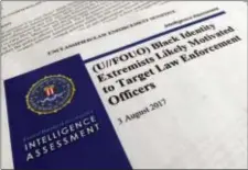  ?? JON ELSWICK - THE ASSOCIATED PRESS ?? Shown is the cover page of a FBI report on the rise of black “extremists” in Washington. The report is stirring fears of a return to practices of the Civil Rights era, when the agency notoriousl­y spied on activist groups without evidence they had...