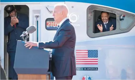  ?? ?? Amtrak workers inside an Acela train applaud President Joe Biden on Monday as he discusses upgrading the 150-year-old Baltimore and Potomac Tunnel, alleviatin­g the bottleneck that has stifled the Amtrak and freight rail Northeast Corridor route between Washington, D.C., and New Jersey.