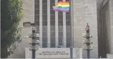  ?? (Yonatan Sindel/Flash90) ?? A PRIDE FLAG fies in front of the Great Synagogue on King George Street ahead of the Jerusalem March for Pride and Tolerance in 2018.