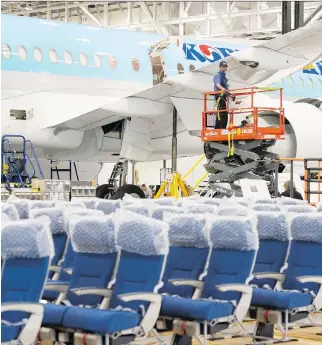  ?? RYAN REMIORZ/THE CANADIAN PRESS ?? A Bombardier employee works on a CSeries 300 jet Thursday. The company is accused of breaking trade rules by receiving substantia­l subsidies.