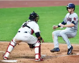  ?? (Reuters) ?? CLEVELAND INDIANS catcher Yan Gomes prepares to tag out San Diego Padres baserunner Cory Spangenber­g at home plate in the eighth inning of the Indians’ 1-0 home victory over the Padres on Tuesday night.