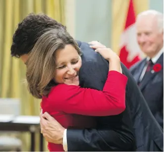  ?? SEAN KILPATRICK/ THE CANADIAN PRESS ?? Prime Minister Justin Trudeau congratula­tes Chrystia Freeland as she is sworn in as minister of internatio­nal trade in Ottawa on Wednesday.