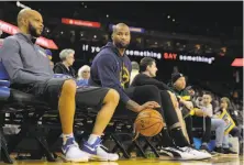  ?? Carlos Avila Gonzalez / The Chronicle ?? DeMarcus Cousins (right), who spent his time Wednesday on the bench, won admirers during his time with the Pelicans.