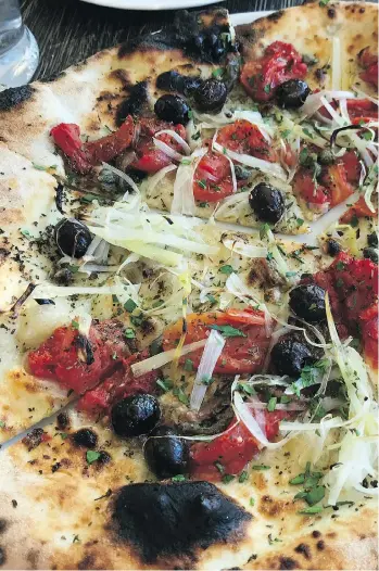  ??  ?? Amalfi Pizza at Sopra Sotto Pizzeria features tasty ingredient­s on a wood-fired gluten-free crust.