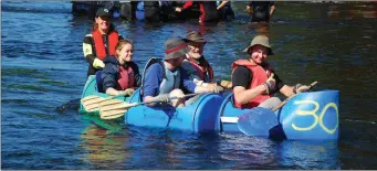  ??  ?? Sarah Vaughan of the Blackwater Search and Rescue Unit giving a helping hand to Pat Casey, Oisin Casey, Alan Casey and Niamh Mulcahy in the raft ‘Fauzy’.