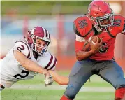  ?? [PHOTO BY BRYAN TERRY, THE OKLAHOMAN] ?? Carl Albert’s Dadrion Taylor runs past Ada’s Christian Maloy last week. The top-ranked Titans travel to No. 3 Ardmore on Friday in The Oklahoman’s top game of the week.