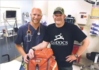  ?? CLYDE MUELLER/THE NEW MEXICAN ?? From left, Dr. Chris Hammond of the Los Alamos Medical Center and Tylerr Jones, a Santa Fe City firefighte­r/EMT, left Friday evening for the front lines of Mosul, Iraq. They are part of a team being deployed by Global Outreach Doctors, a Santa Fe based...