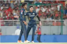 ?? ?? Gujarat Titans captain Shubman Gill (R) and Sai Kishore celebrate a wicket.