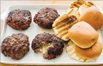  ?? The Associated Press ?? Recipe for Jucy Lucy burgers also appears in The Complete Cook’s Country TV Cookbook, 2017.