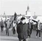  ?? PETR DAVID JOSEK/AP ?? The Czech Republic last week had a record 8,500 people hospitaliz­ed with COVID-19. Above, a man walks across the Charles Bridge on Feb. 25 in Prague.