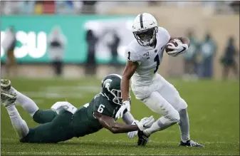  ?? AL GOLDIS — THE ASSOCIATED PRESS ?? Penn State receiver KJ Hamler, right, eludes Michigan State’s David Dowell (6) during the second quarter of an NCAA college football game, Saturday.