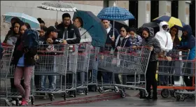  ?? (AP/Ben Margot) ?? Shoppers vying for dwindling supplies wait to enter a Costco on Saturday in San Leandro, Calif.