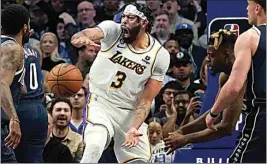  ?? LM OTERO / AP ?? Los Angeles Lakers forward Anthony Davis (3) reacts after scoring on a slam dunk against the Dallas Mavericks during the fourth quarter of an NBA basketball game in Dallas on Sunday.