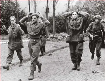  ??  ?? ABOVE: Soldiers of the British 11th Parachute Battalion surrender. The battalion was decimated at Arnhem after it was caught in the open while trying to take high groundLEFT: In an image that gives a sense of the ambition of Operation Market Garden, waves of paratroope­rs from the First Allied Airborne Army land in the Netherland­s in September 1944. But due to planning failures, argues Antony Beevor, many men didn’t make it home