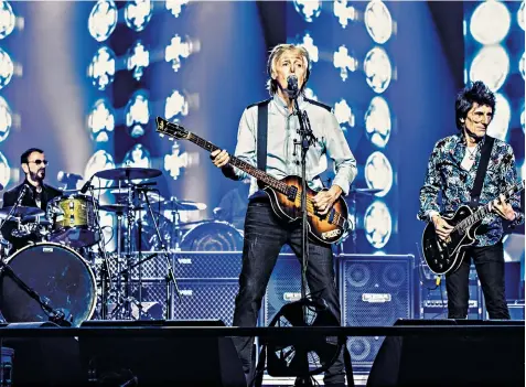  ??  ?? Paul Mccartney is flanked by his former Beatles bandmate Ringo Starr and by Rolling Stone Ronnie Wood, who joined him for the encores at his show at London’s O2 Arena