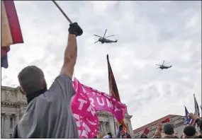  ?? (The New York Times/Victor J. Blue) ?? Marine One, with President Donald Trump aboard, flies above supporters gathered for a rally Saturday at Freedom Plaza in Washington. Trump was on his way to the Army-Navy football game.