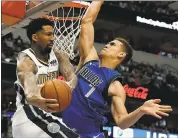  ?? TONY GUTIERREZ — ASSOCIATED PRESS ?? Nuggets forward Wilson Chandler is forced to look for a teammate as the Mavericks’ Dwight Powell blocks his path.