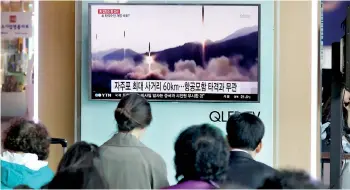  ??  ?? People watch a TV broadcasti­ng of a news report on North Korea's missile launch, at a railway station in Seoul, South Korea, April 29. REUTERS/Kim Hong-Ji