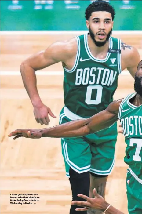  ?? AP ?? Celtics guard Jaylen Brown blocks a shot by Knicks’ Alec Burks during final minute on Wednesday in Boston.