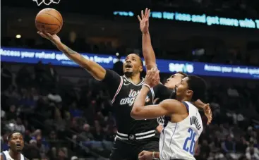  ?? AP/LM OTERO PHOTO ?? LOS ANGELES Clippers forward Norman Powell (24) shoots against Dallas Mavericks guard Spencer Dinwiddie (26) and center Dwight Powell (7) during the first quarter of an NBA basketball game in Dallas, Tuesday, Nov▪ 15, 2022▪