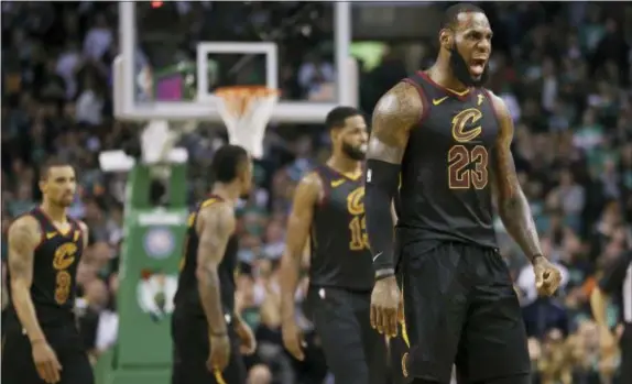  ?? ELISE AMENDOLA — THE ASSOCIATED PRESS ?? Cleveland Cavaliers forward LeBron James, right, celebrates a basket during the second half in Game 7 of thel Eastern Conference finals against the Boston Celtics on Sunday in Boston.