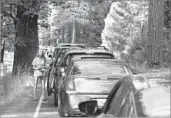  ?? Brian van der Brug Los Angeles Times ?? CAR TRAFFIC is at a standstill on the Yosemite Valley floor while a bus lane is empty on July 15.