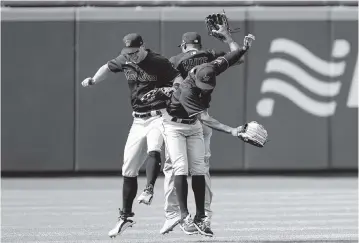  ?? JOHN MINCHILLO AP ?? Marlins outfielder­s, from left, Corey Dickerson, Starling Marte and Magneuris Sierra celebrate Saturday after the Marlins’ shutout win in New York. Marte had two hits, including a double, in four at-bats in the game.