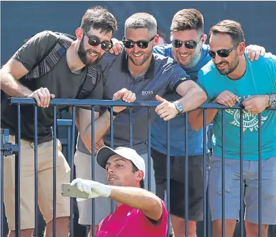  ?? Picture: Getty. ?? Francesco Molinari of Italy takes a selfie with golf fans during a practice round.