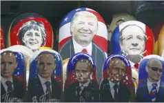  ?? (Reuters) ?? RUSSIAN NESTING dolls bearing the faces of Donald Trump and other world leaders are displayed at a souvenir shop in Moscow.
