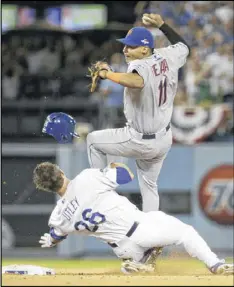  ?? GREGORY BULL / AP ?? The Dodgers’ Chase Utley takes out Mets shortstop Ruben Tejada to break up a double play in Game 2 Saturday night. Tejada had his right leg broken on the play.