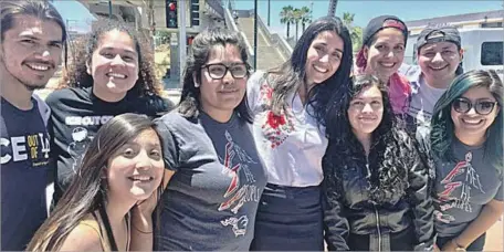  ?? National Day Laborer Organizing Network via Associated Press ?? CLAUDIA RUEDA, fourth from right in black jacket, and her attorney Monika Langarica, white shirt at center, celebrate Rueda’s release from a detention center in San Diego on Friday. A judge ordered that Rueda be freed while her immigratio­n case is...