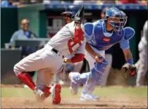  ?? CHARLIE RIEDEL — THE ASSOCIATED PRESS ?? Boston Red Sox’s Mookie Betts, left, beats the tag by Kansas City Royals catcher Drew Butera as he slides home to score on a sacrifice fly by Steve Pearce during the third inning of a baseball game Sunday in Kansas City, Mo.