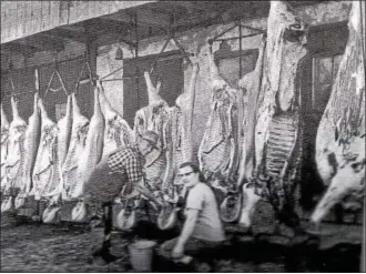  ?? SUBMITTED PHOTO ?? Here, George Adam and son butcher a hog. The meat that wasnít eaten fresh was also cooked and stored in lard be it cans and once, crocks. Other meat was smoked or salted for preservati­on. The dead hog was hung inverted as such for easy removal of intestines and organs during first cut.