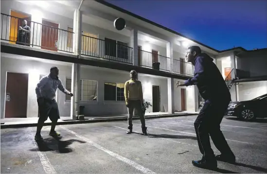  ?? Photograph­s by Gary Coronado Los Angeles Times ?? ALFREDO BETANCOURT, left, of Mexicali, Mexico; Ivan Perez of Mexicali; and Angel Pompa, of Los Mochis, Mexico, relax at a converted hotel in downtown Salinas.