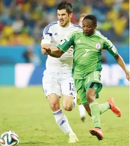  ??  ?? Nigeria’s forward Ahmed Musa (R) challenges Bosnia-Hercegovin­a’s midfielder Mensur Mujdza during the Group F match at the Pantanal Arena in Cuiaba during the 2014 FIFA World Cup on June 21, 2014.