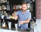  ?? BRIAN RICH/SUN-TIMES ?? Scofflaw bar manager Luke DeYoung says many people formed an initial opinion about gin back when “it was a very different world” as far as options.