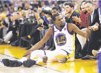  ?? Scott Strazzante / The Chronicle ?? Kevin Durant fist-bumps a fan after being fouled while hitting a three-pointer Wednesday.