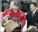  ?? Daily Courier file photo ?? Kelowna Rockets goaltender Kelly Guard accepts the Stafford Smythe Memorial Trophy as tournament MVP at the 2004 Memorial Cup.