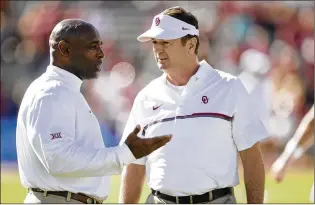  ?? JAY JANNER / AMERICANST­ATESMAN ?? Former Texas coach Charlie Strong (left) talks with Oklahoma coach Bob Stoops before the 2016 rivalry game at the Cotton Bowl in Dallas. Stoops went 11-7 against the Longhorns while in Norman.