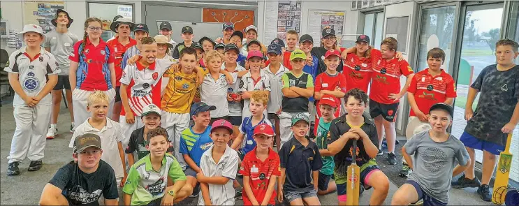  ?? ?? Above: Participan­ts of the Shaun Brown’s Cricket Coaching camp all huddled together for a quick snap inside of the Dubbo Touch Associatio­n building at Bob Dowling Oval.