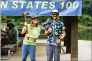  ?? COURTESY FAITH HALL ?? Race winners Nicole Yokum, left, and Ben Quatromoni hold up the winners’ axe after finishing as the top female and male finisher in the 2021Easter­n States 100.