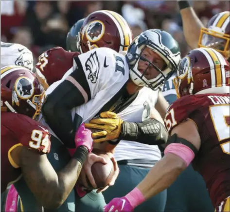  ?? ALEX BRANDON — THE ASSOCIATED PRESS ?? Philadelph­ia Eagles quarterbac­k Carson Wentz, center, is sacked in the second half of an NFL football game against the Washington Redskins, Sunday.