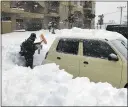  ?? ?? A resident shovels snow off around a car in northern Japan on Saturday.