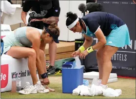  ?? Associated Press ?? Sportsmans­hip: Ons Jabeur from Tunesia, right, helps to Belinda Bencic from Switzerlan­d after sustaining an injury during the WTA tournament final tennis match in Berlin, Germany, Sunday. Jabeur won when Bencic was forced to retire.