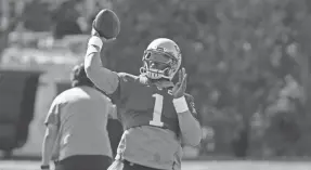  ?? STEVEN SENNE/POOL VIA AP ?? Patriots quarterbac­k Cam Newton throws during a training camp practice Wednesday in Foxborough, Mass. New England coach Bill Belichick says he may use multiple quarterbac­ks in games this season.