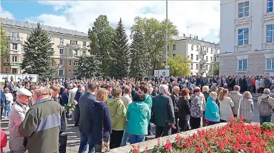  ?? Russian State Atomic Energy Corporatio­n ROSATOM via AP ?? ■ In this grab taken from a footage provided by the Russian State Atomic Energy Corporatio­n ROSATOM press service, people gather for the funerals Monday of five Russian nuclear engineers killed by a rocket explosion in Sarov, the closed city, located 230 miles east of Moscow. Thousands of people have attended the burial of five Russian nuclear engineers killed by an explosion during tests of a new rocket. The engineers, who died on Thursday, were laid to rest Monday in the city of Sarov that hosts Russia’s main nuclear weapons research center.