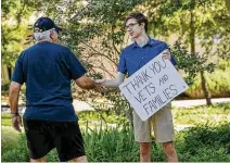  ??  ?? Nicholas Brainard, 17, thanks Vietnam War veteran Gary Dennett at the Memorial Day observance at the Georgetown-Williamson County Veterans Memorial Plaza in Sun City Texas on Monday. Hundreds attended the event, including keynote speaker U.S. Sen. John...