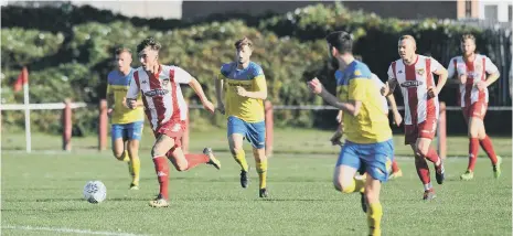  ??  ?? Ryhope CW (red/white) power forward against Ashton Athletic.