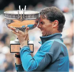  ?? / IAN MACNICOL/GETTY IMAGES ?? Nadal with the French Open trophy on Sunday at Roland Garros. It was his 17th slam title.